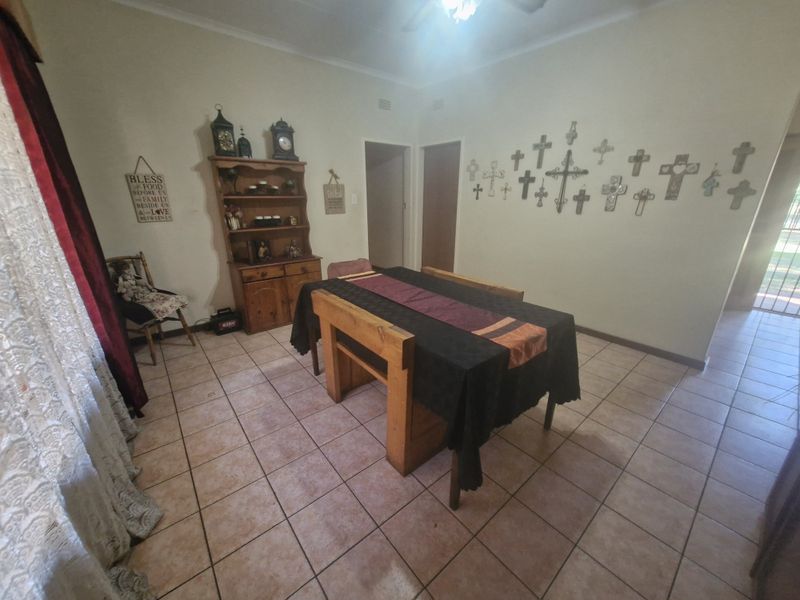 A dining room featuring ceramic tile flooring and a ceiling fan, providing a functional space for meals.
