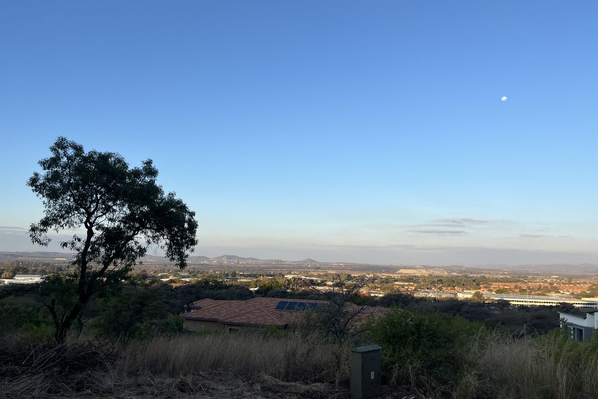 A scenic elevated view overlooking the surrounding landscape and distant urban area, capturing the natural terrain and horizon.