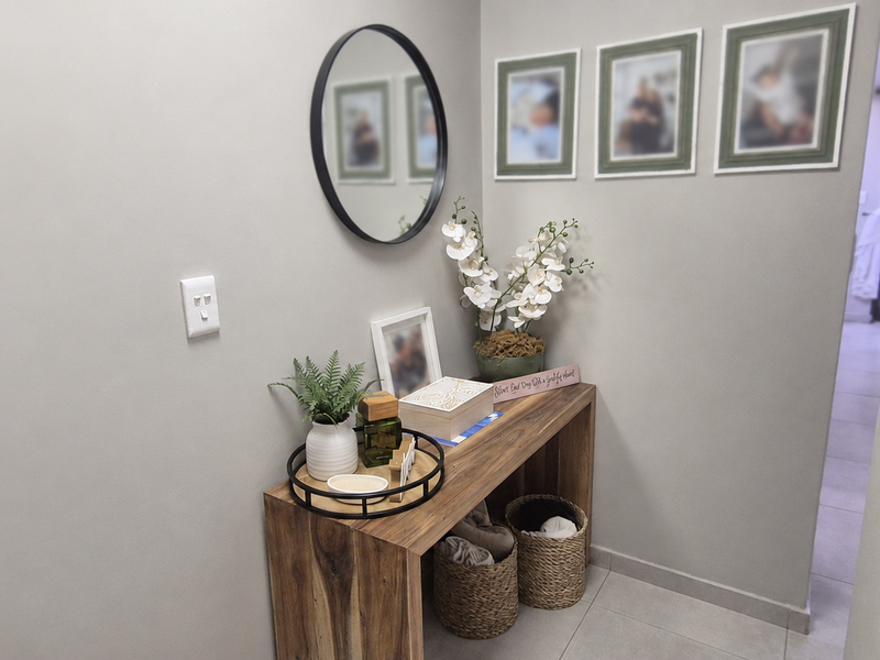 A clean and well-maintained hallway featuring neutral wall tones and tiled flooring, providing a welcoming transition between living spaces.