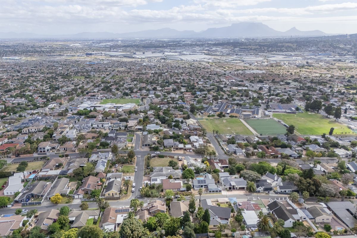 An elevated aerial view showcasing the surrounding residential neighbourhood and local landscape.