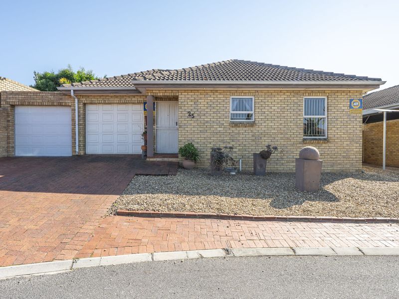 Front elevation of a single-story brick house featuring a paved driveway, single garage, and low-maintenance gravel garden.