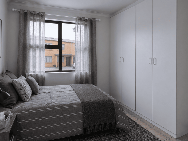 A well-maintained bedroom featuring neutral tiled flooring, built-in white cupboards, and an aluminium-framed window providing natural light.