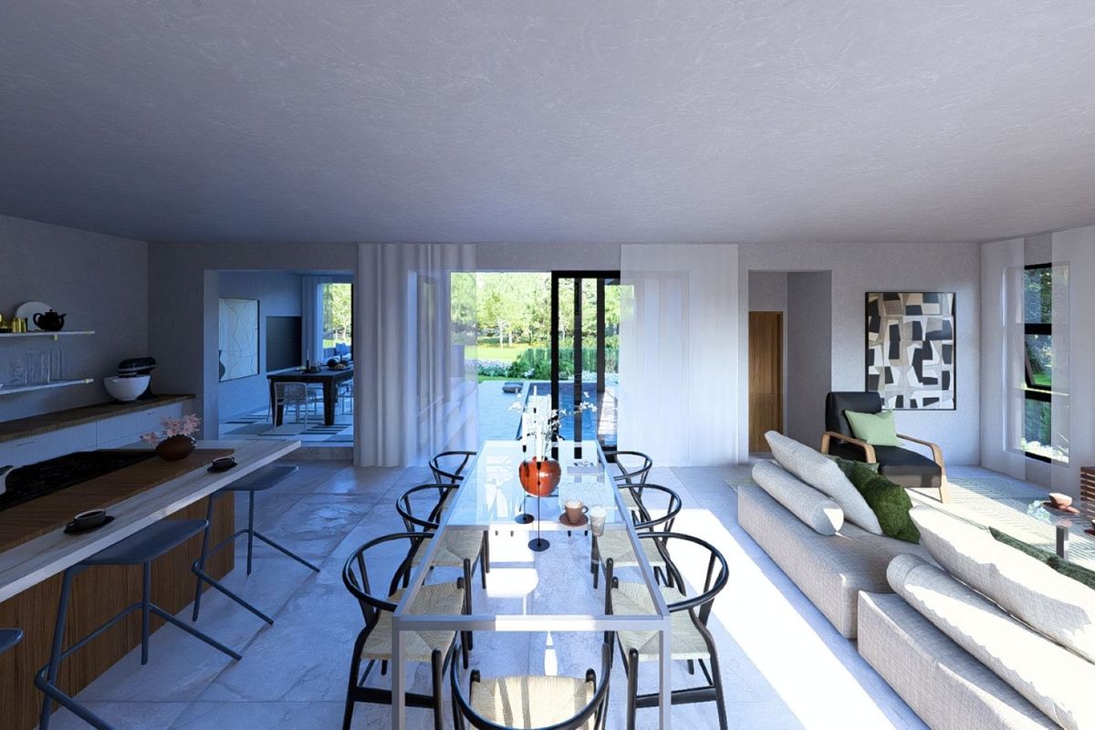 Spacious open-plan living, dining, and kitchen area featuring modern finishes, stone flooring, and large sliding doors opening to the outdoor pool area.