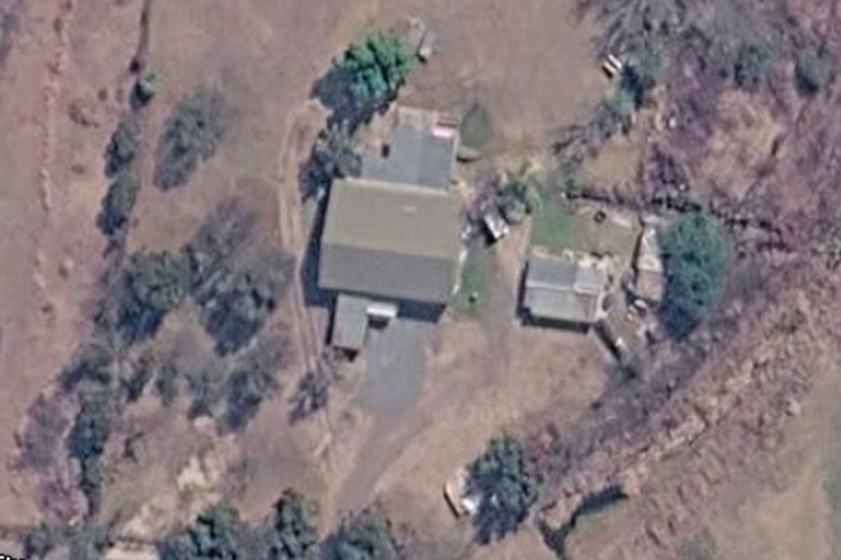 Aerial view of the small holding property showing the main dwelling, outbuilding, and surrounding land layout.