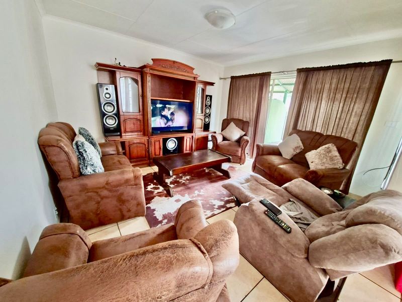 A living room featuring tiled flooring and a central ceiling light fixture, providing a functional space for relaxation.