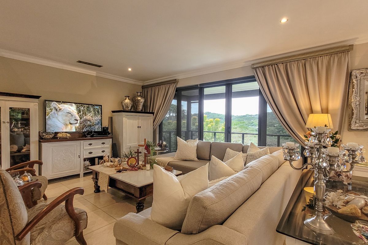 Spacious living room featuring large sliding glass doors that provide natural light and access to an outdoor balcony with scenic views.