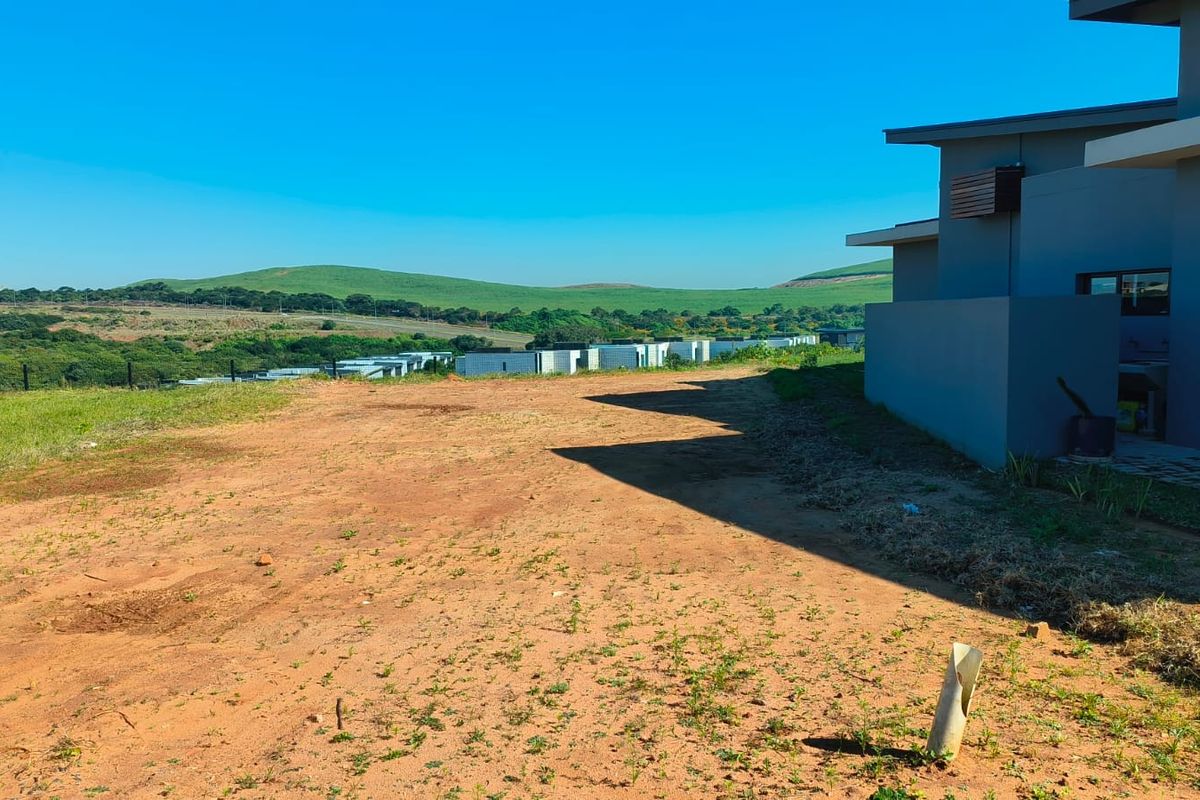 A view of the vacant residential land area adjacent to the modern building structure, featuring open space and scenic landscape views.