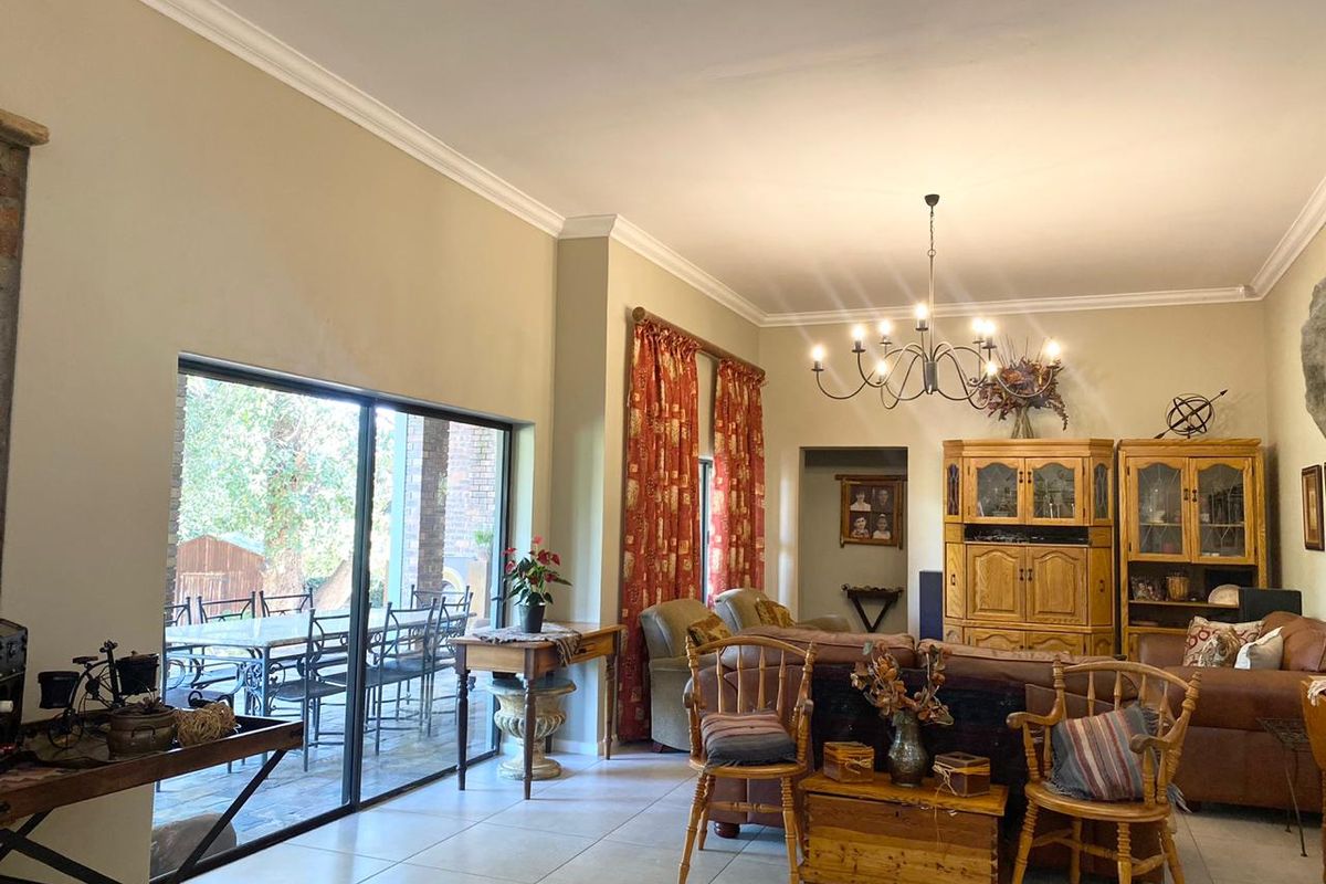 Spacious living area featuring large sliding glass doors that provide seamless access to the outdoor patio and garden.