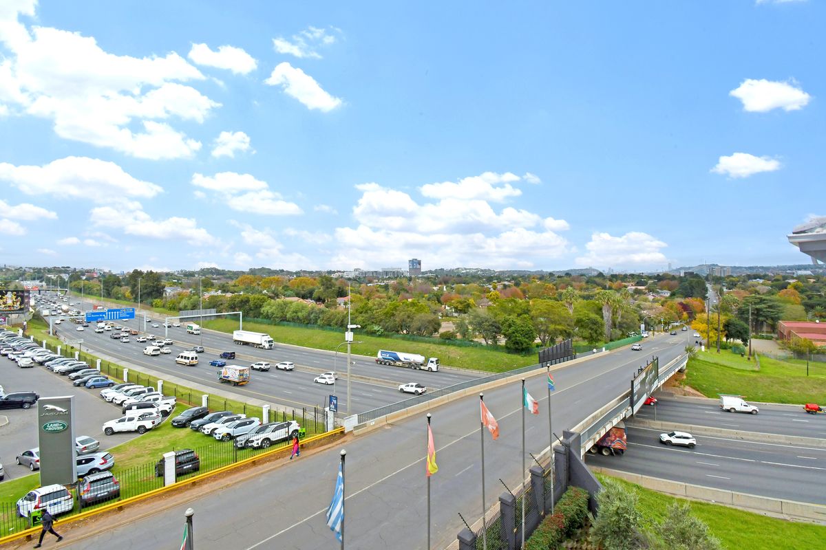 An elevated aerial view overlooking a major highway intersection and surrounding suburban landscape.