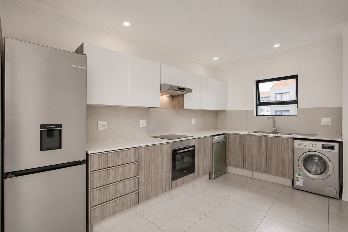 Modern kitchen featuring sleek two-tone cabinetry, stone countertops, integrated appliances, and high-quality tiled flooring in a clean, contemporary design.