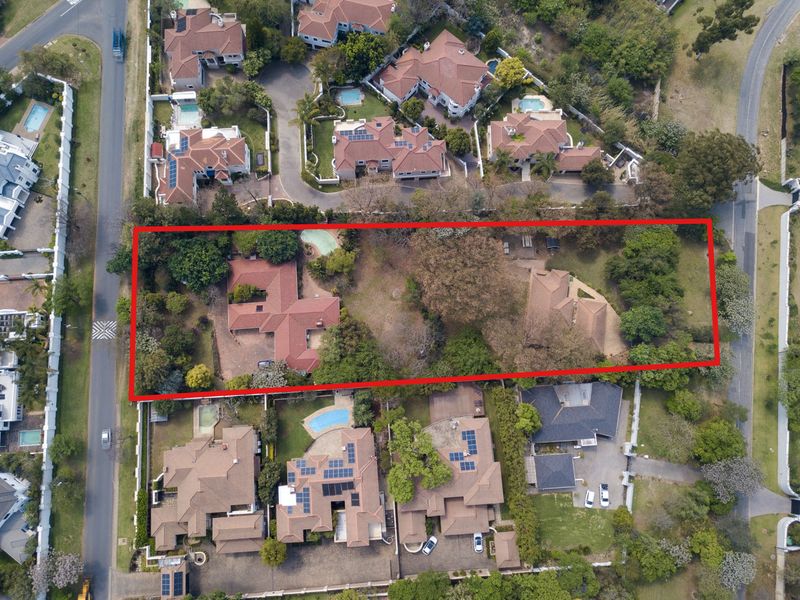 Aerial view of a large residential property plot featuring established trees and garden space within a suburban estate setting.