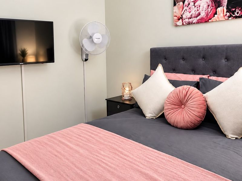 A well-maintained bedroom featuring neutral wall finishes and a clean, modern aesthetic.