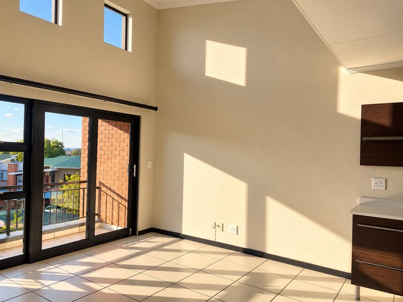Bright open-plan living area featuring high ceilings, tiled floors, and large sliding doors leading to a private balcony with neighborhood views.