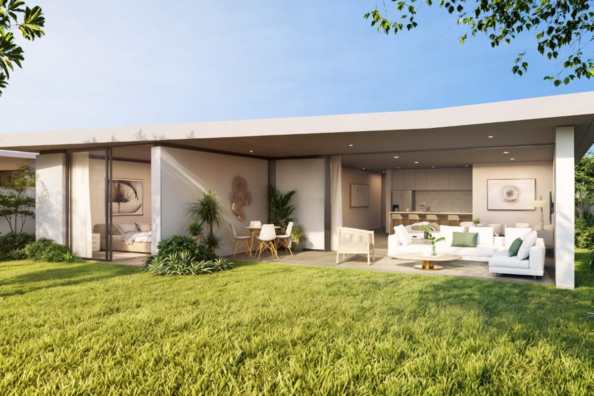 A modern, open-plan residence featuring a seamless transition between the interior living spaces and a spacious covered patio overlooking a landscaped garden.