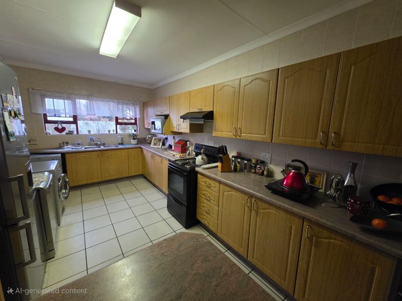 A functional kitchen featuring wood-look cabinetry, tiled flooring, a built-in oven with extractor fan, and ample counter space with a tiled backsplash.