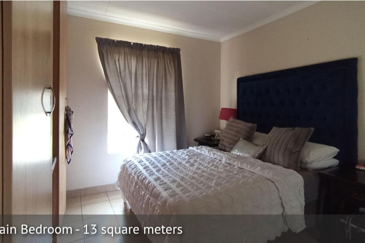A bedroom featuring tiled flooring and built-in cabinetry.