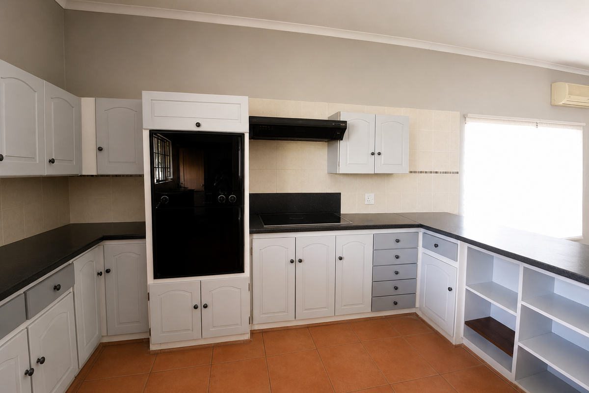 A functional kitchen featuring built-in cabinetry, a dark countertop, integrated oven, hob, extractor fan, and tiled flooring.