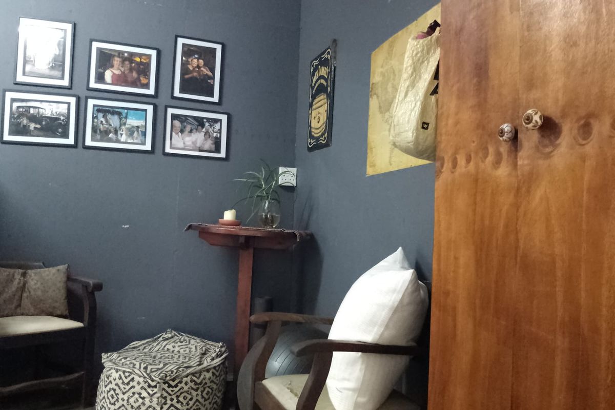A corner view of a room featuring dark grey painted walls and a built-in wooden cabinet.
