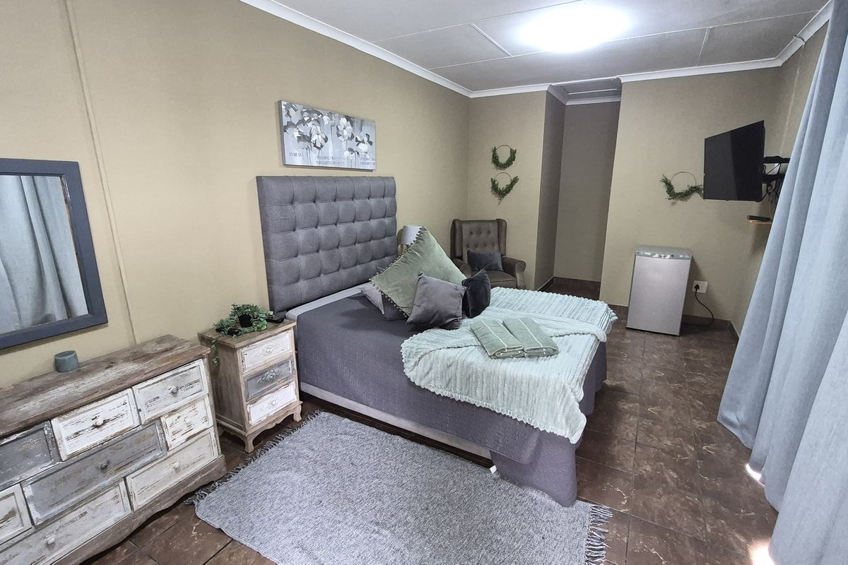 A bedroom featuring tiled flooring, neutral wall finishes, and a standard ceiling layout.