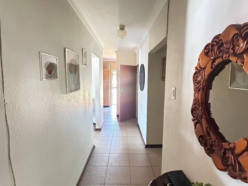 A functional interior hallway featuring tiled flooring and access to multiple rooms within the home.