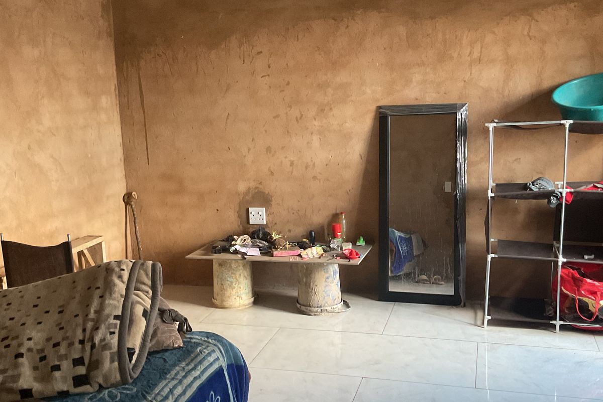 A bedroom featuring tiled flooring and unfinished, raw plaster walls, providing a blank canvas for future interior finishing and decoration.