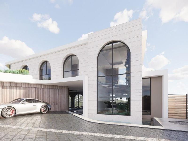 A modern architectural facade featuring arched windows, timber cladding, and a paved driveway, showcasing a contemporary residential design.