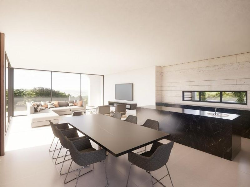 Modern open-plan living and dining area featuring a sleek marble kitchen island, stone feature wall, and expansive floor-to-ceiling windows with natural light.