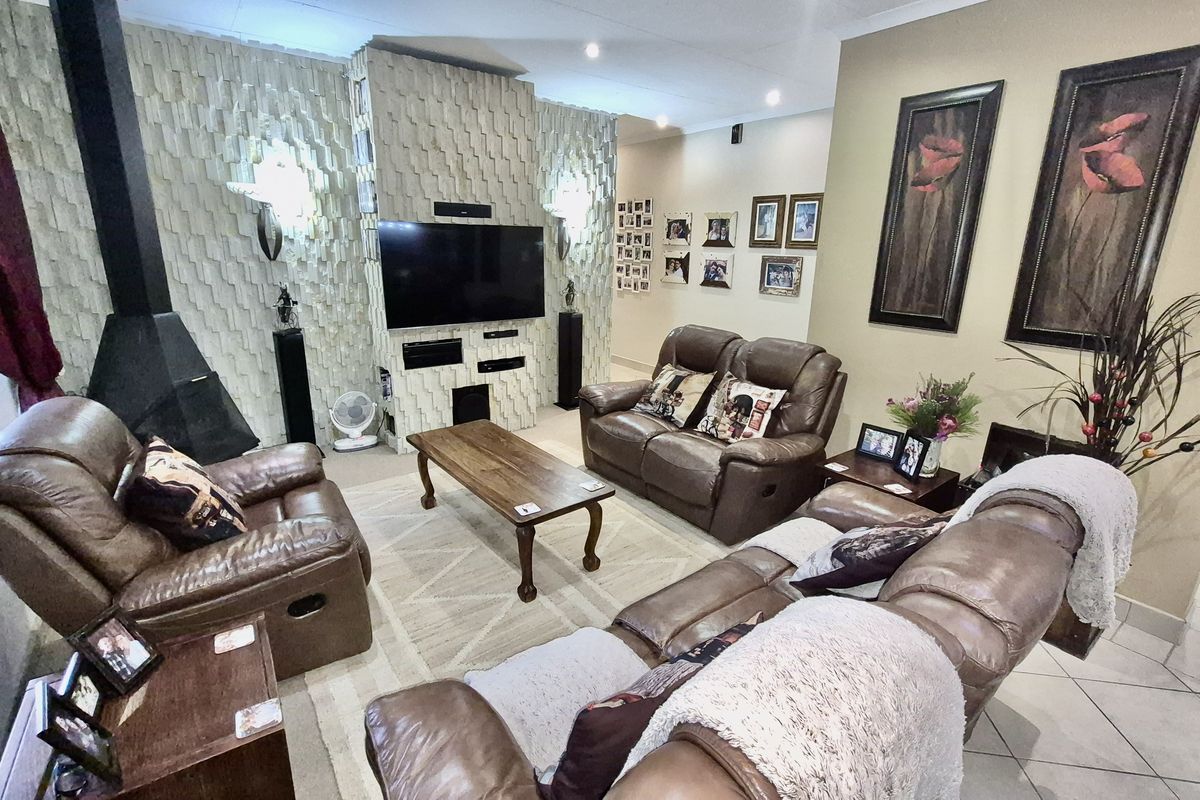 A living room featuring a prominent textured feature wall with a built-in fireplace and integrated television mounting area.