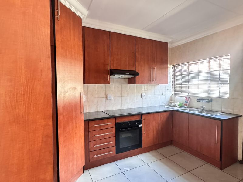 Charming 3 Bedroom Family Home with Spacious Yard and Drive-Through Garage in Ext 18 - Photo 2