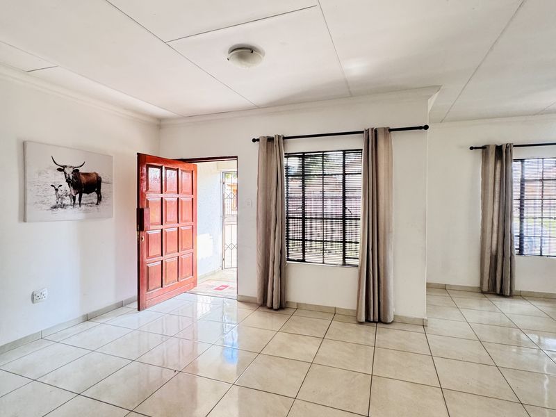 Charming 3 Bedroom Family Home with Spacious Yard and Drive-Through Garage in Ext 18 - Photo 7