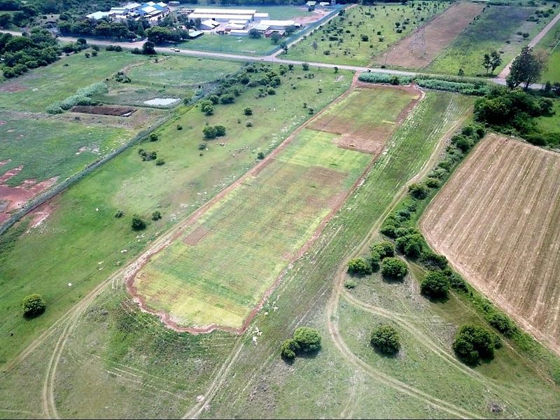 An aerial view of the farm property, showcasing expansive open land, cultivated fields, and surrounding rural landscape.
