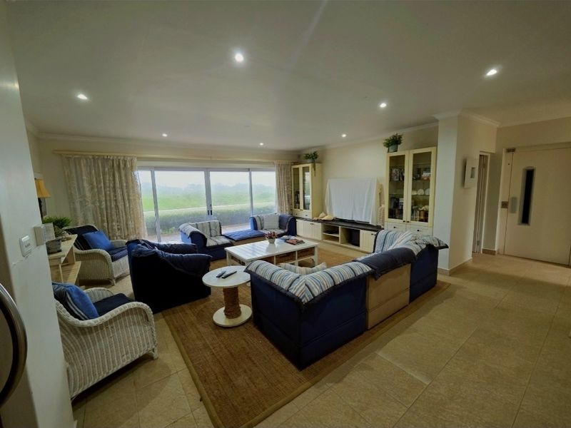 Spacious open-plan living area featuring large sliding glass doors that provide natural light and access to the outdoor space.