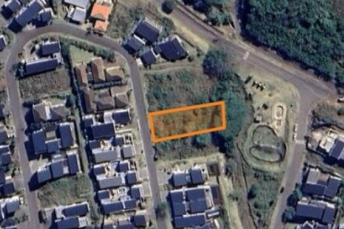 An aerial view of a vacant residential land plot situated within an established neighborhood.