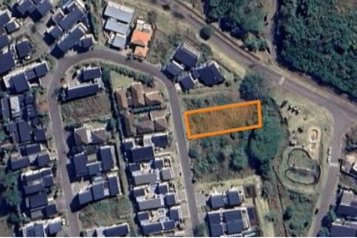 Aerial view of a vacant residential plot highlighted in an urban neighborhood setting.