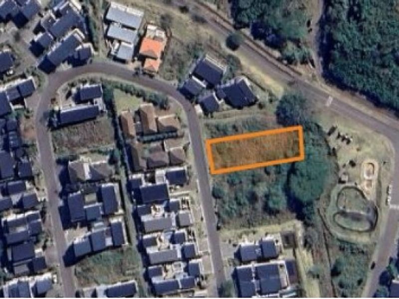 Aerial view of a vacant residential plot highlighted in an urban neighborhood setting.
