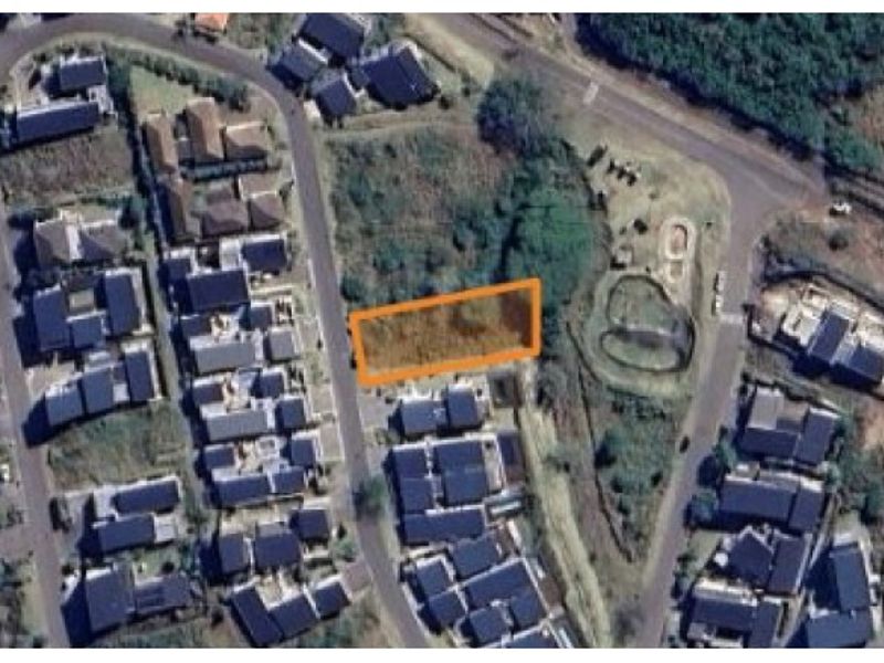Aerial view of a vacant residential land plot situated within an established suburban neighborhood.