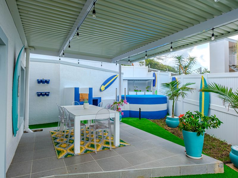 Covered outdoor patio featuring a built-in braai area, tiled flooring, and a small plunge pool, perfect for relaxed outdoor entertaining.