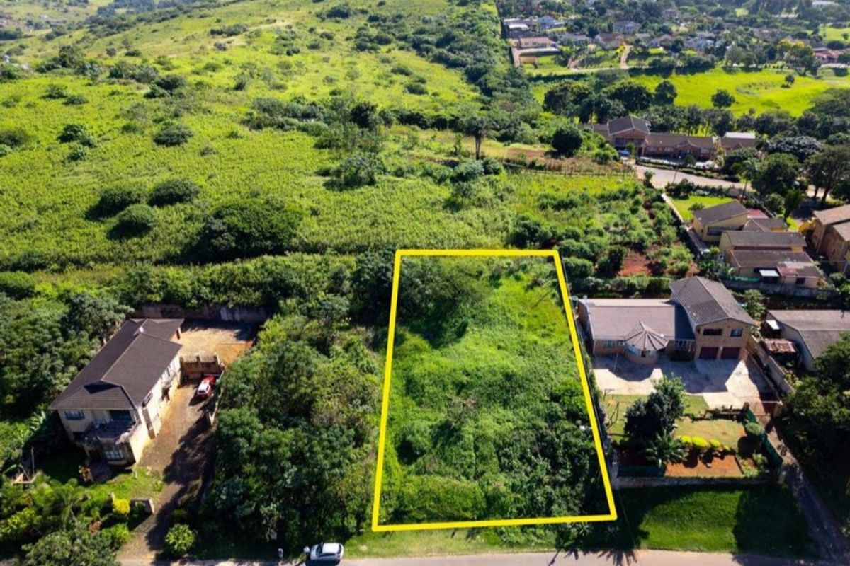 An aerial view of a vacant residential plot of land, highlighting its boundaries and surrounding neighborhood context.