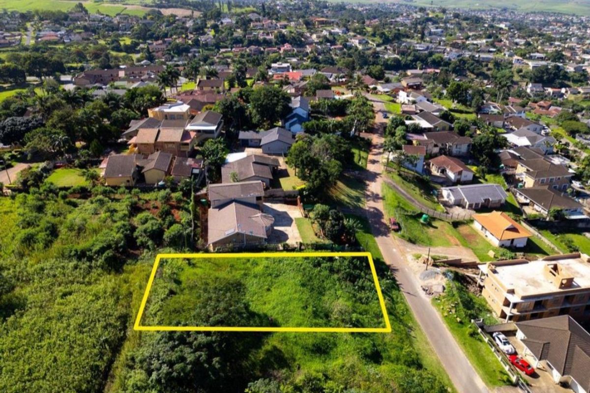 Aerial view of a vacant residential plot situated in an established suburban neighborhood, offering potential for new development.