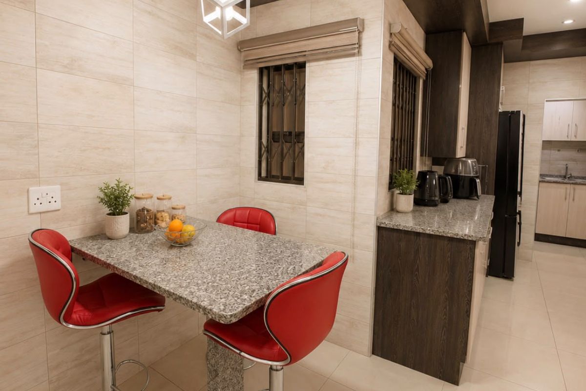 Modern kitchen featuring granite countertops, custom cabinetry, tiled wall finishes, and stylish pendant lighting, creating a functional and contemporary culinary space.