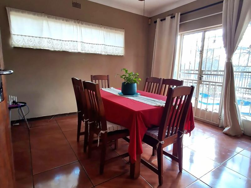 Dining room featuring ceramic floor tiles, a ceiling fan, and a sliding glass door providing access to the outdoor area.