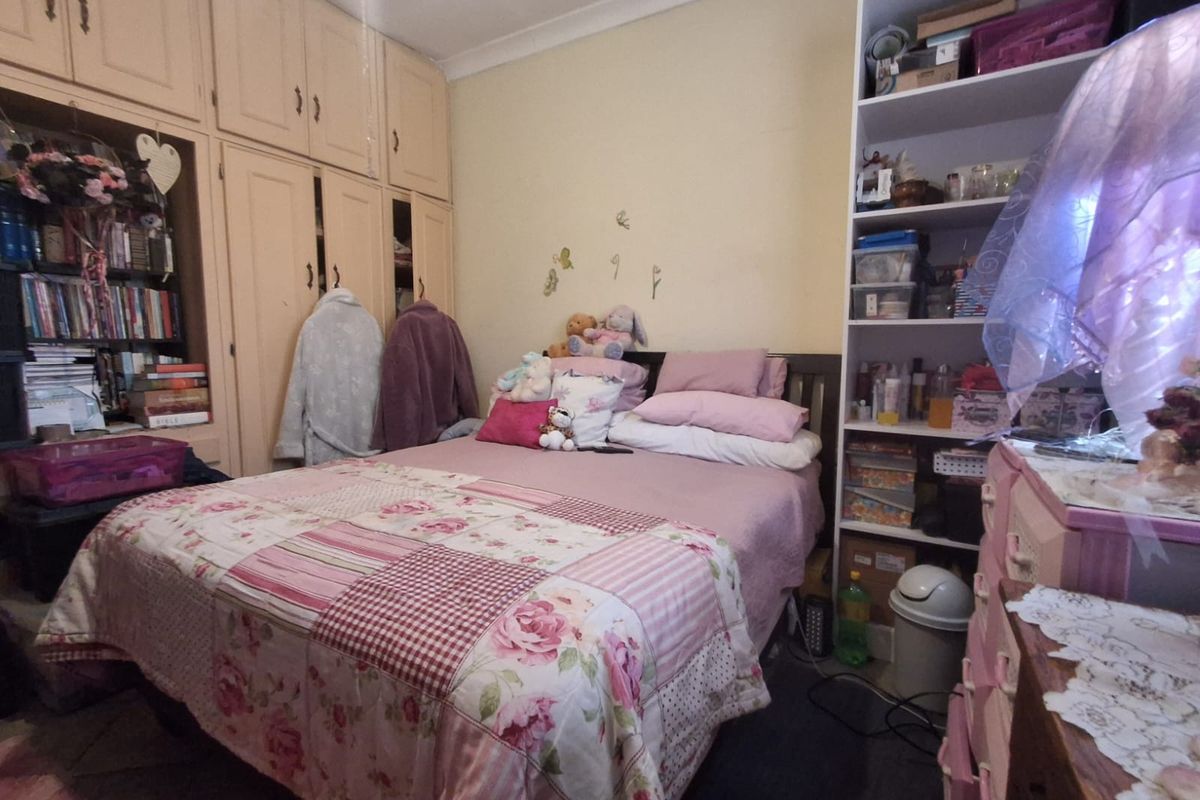 A bedroom featuring extensive built-in cabinetry and coving, offering ample storage space within a functional layout.