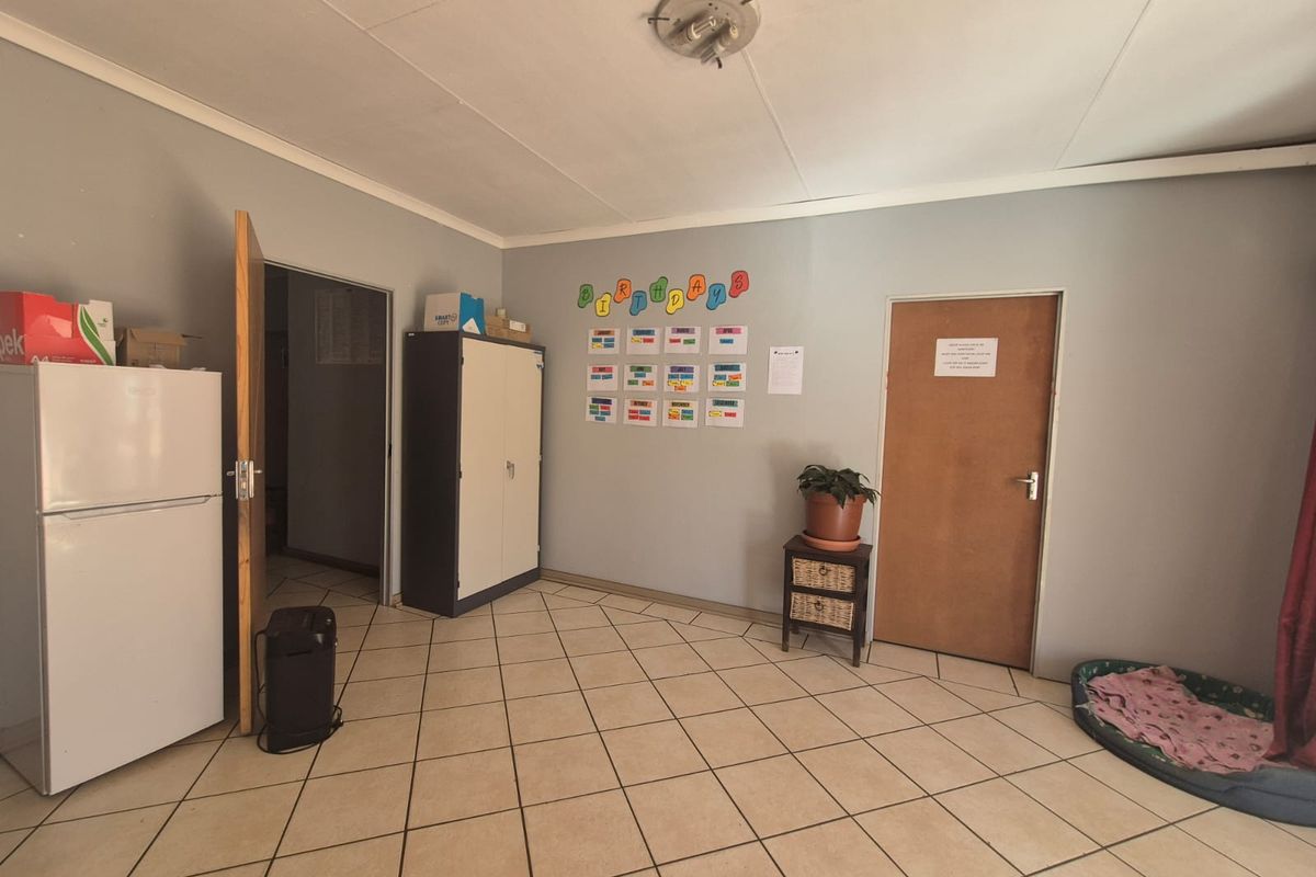 A functional living space featuring neutral wall tones and tiled flooring, providing a versatile area for various residential uses.