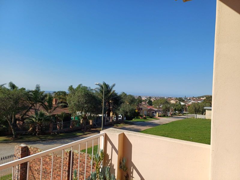 An elevated balcony offering an expansive view over the surrounding residential neighborhood and streetscape.