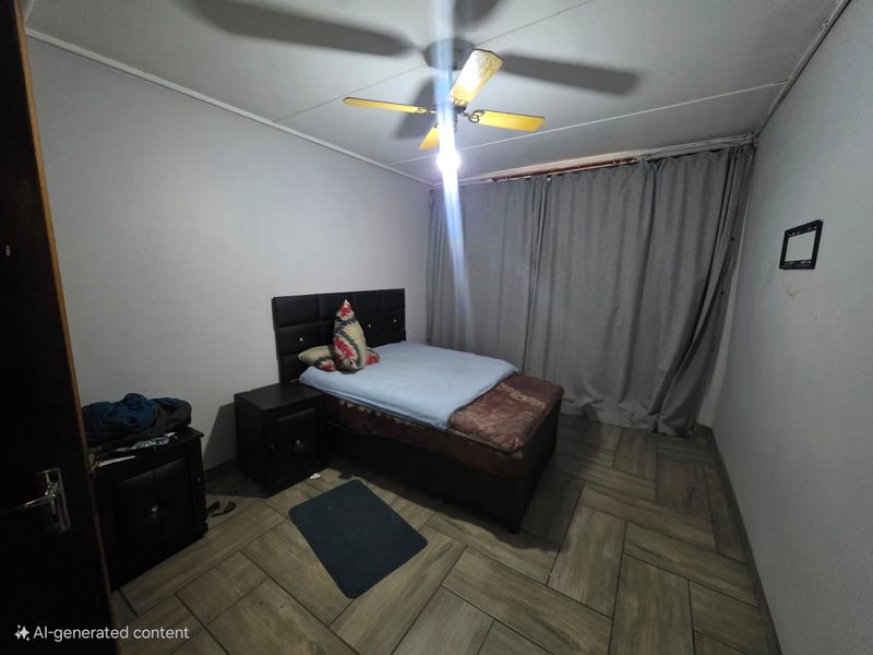 A bedroom featuring tiled flooring and a ceiling fan, providing a functional space for rest.