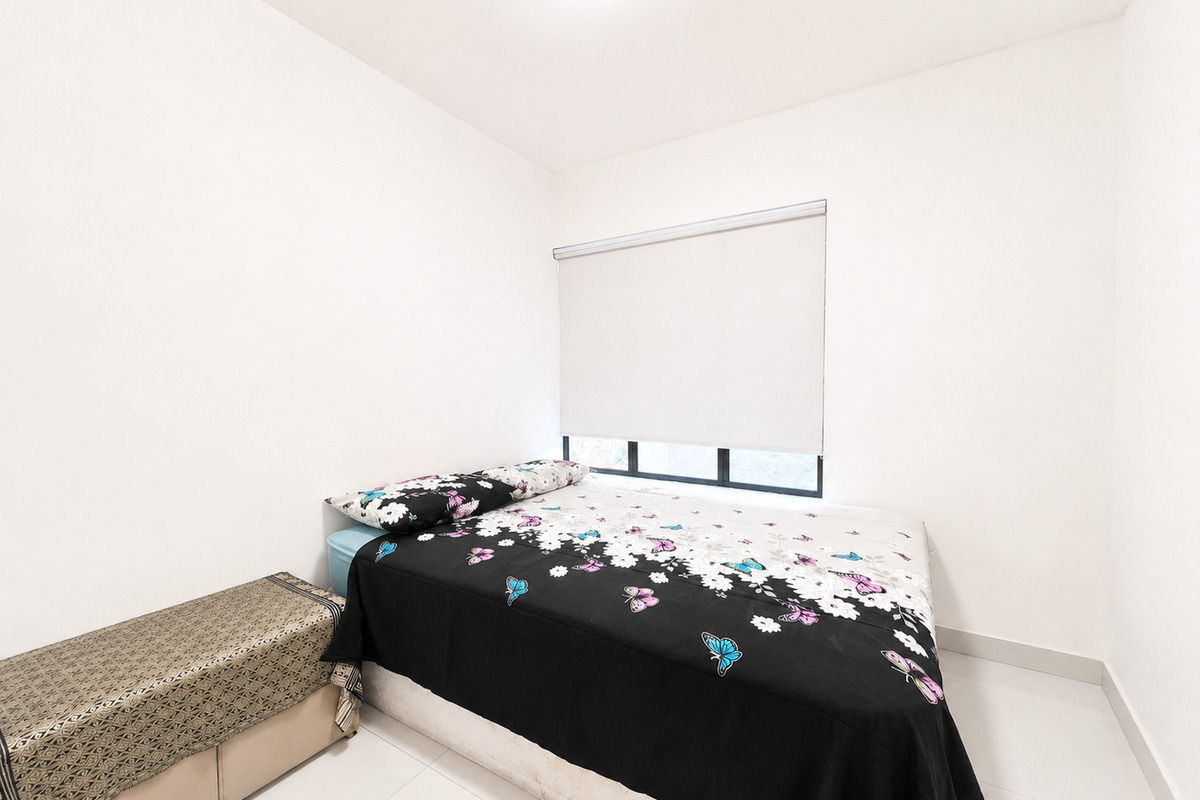 A clean, minimalist bedroom featuring white walls, tiled flooring, and a functional roller blind for privacy.