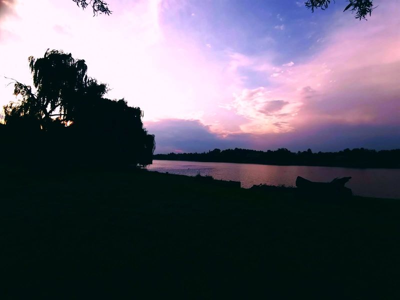 A scenic sunset view over the property's waterfront, showcasing the tranquil landscape and natural surroundings.