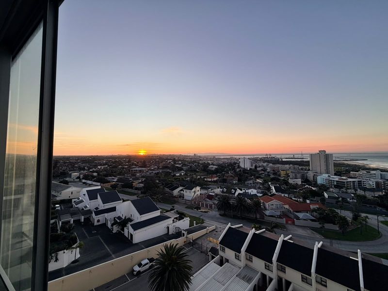 A scenic elevated sunset view overlooking the surrounding residential neighborhood and coastline.