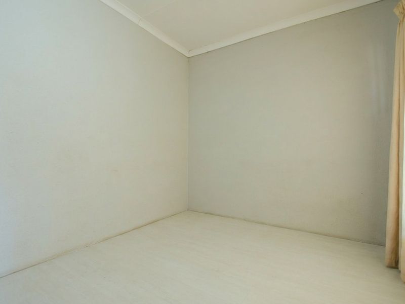 A vacant bedroom featuring neutral walls, coving, and skirting boards, offering a blank canvas for personalization.