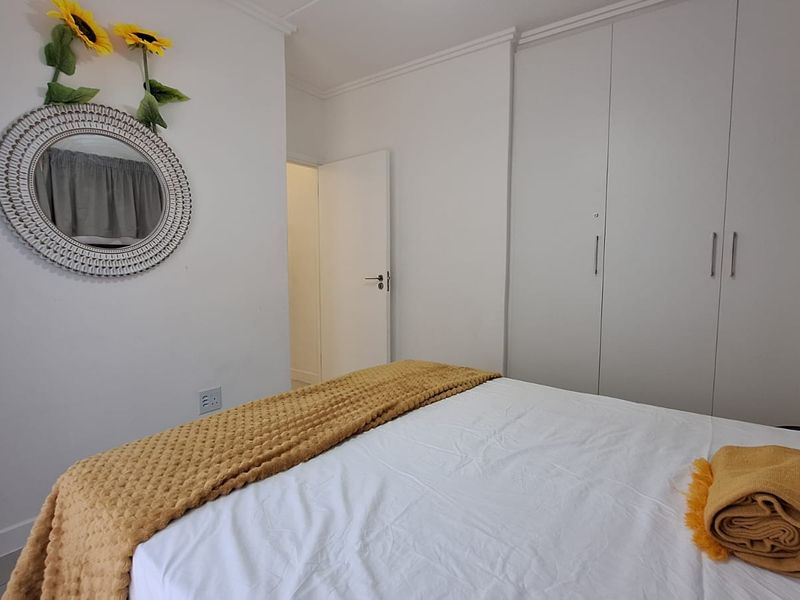 A well-maintained bedroom featuring built-in wardrobes and classic coving detail, providing a clean and functional living space.